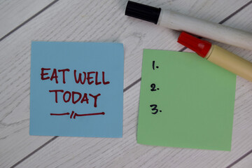 Eat Well Today write on sticky notes and supported by additional services isolated on Wooden Table.