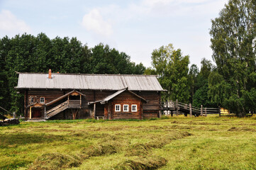 Fototapeta na wymiar Panoramic view of a large wooden log house in a clearing. September 05, 2020, Arkhangelsk, Russia.