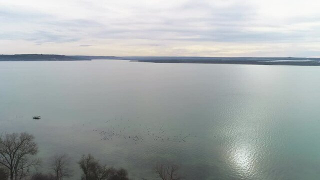 Flight by the lake adjacent to the city