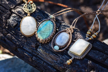 Collection of mineral gemstones jewelry necklaces on natural woody background