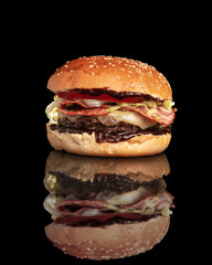 barbecue burger with bacon on a black background