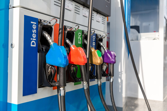 Fuel Pump, Gas Station, Gasoline. Colorful Petrol Pump Filling Nozzles Isolated On White Background , Gas Station In A Service In Warm Sunset. Head Fuel Vehicle Refueling Facility In Asia