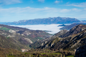 Fototapeta na wymiar Landscape of a sea of ​​clouds and the Basilica of Covadonga in the background in the mountains of the Lakes of Covadonga.The photograph is taken in horizontal format.