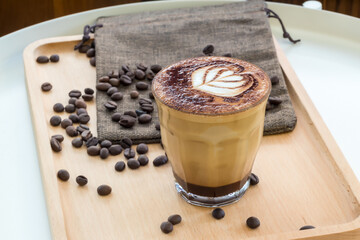 Coffee Latte Art. The coffee arts. Hot coffee in a white cup on wooden table. Hot chocolate Nutella latte art on wood table.