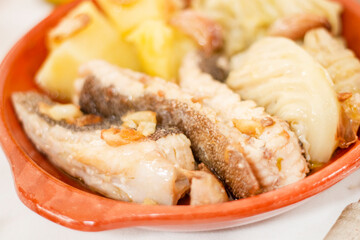 Homemade ray fish with potatos and garlic
