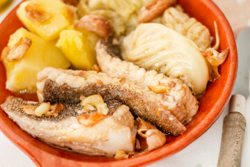 Homemade ray fish with potatos and garlic