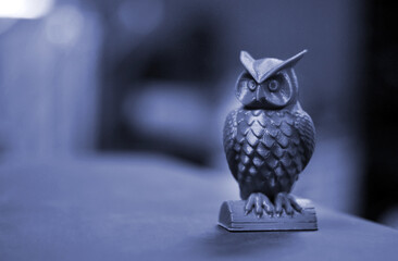 The green form in the form of a small owl created on 3d printer dark background
