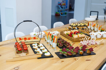 setting a wooden table for a holiday with various snacks