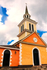 Fototapeta premium Little colorful Caribbean church in orange and yellow (Trois Ilet, Martinique, France)