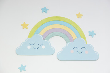 multicolored rainbow and clouds on a white background. Interior decoration