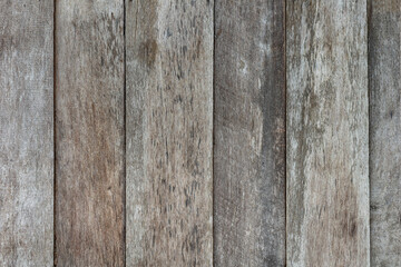 Damaged grungy rural stained exterior vertical oak ranch planks of country barn. Old faded dirty ragged gnarled surface wooden panel parquet. Rustic lumber hard laths fence for 3D siding grunge design