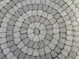 View of the center of the stone pattern, paving stones in the form of a circle. Laying stone around