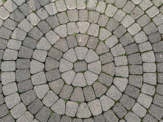 View of the center of the stone pattern, paving stones in the form of a circle. Laying stone around