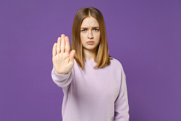Young serious strict disappointed student woman 20s wearing purple knitted sweater do stop palm...