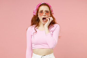 Young shocked surprised amazed scared indignant confused woman 20s wear rose clothes bandana...