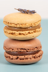 Cake macaron or macaroon on turquoise background from above, colorful almond cookies, pastel colors, vintage card