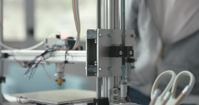 Smart student using a 3D printer in the lab