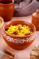 Indian Food Maharashtra Poha with Peanuts in a Pottery Bowl