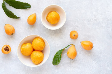 Loquat sorbet, ice cream with fresh fruits in bowl. Top view