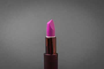 Bright lipstick on a dark gray background.