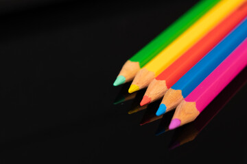 color pencils on black background