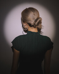 Back of a blond woman with a bun hairstyle