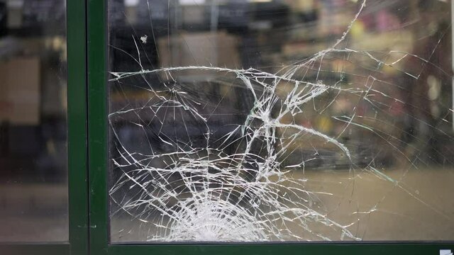 Broken store glass. Shattered front  glass entrance vandalization