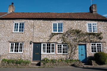 Exterior View of Old Terraced Cottages Houses on a Street in an English Village
