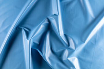 surface with folds of artificial leather for sewing clothes in blue sky colore