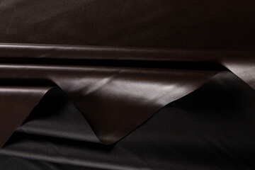 surface with folds of artificial leather for sewing clothes dark chocolate color