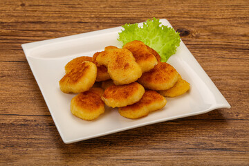 Fried chicken nuggets served salad leaves