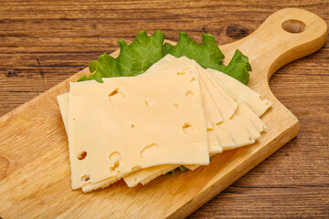 Sliced yellow cheese over board