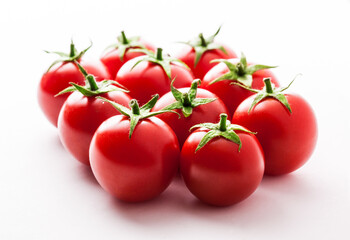 Tomatoes stacked vibrant fresh large ready to eat kitchen arrangement isolated on white with copy space selective focus studio shot
