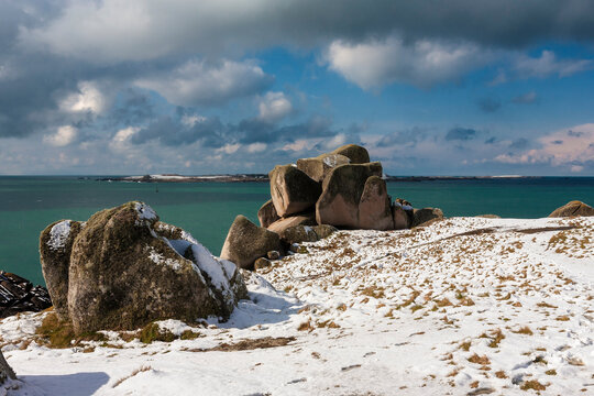 A rare fall of snow on Peninnis Head, St. Mary's, Isles of Scilly, UK, with Gugh and St. Agnes across St. Mary's Sound