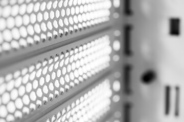 Horizontal ventilation grille. Air vents. Metal construction. Angle view. Black and white tones.