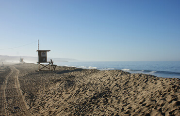 Fototapeta na wymiar Lifeguard tower on beach with morning haze
