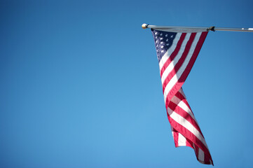American flag with bright blue sky
