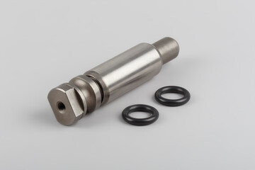 The repair kit for the spring from the pin bushing and gaskets lies on a gray background. Bushing and finger for truck repair. automotive components for heavy vehicles