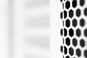 Vertical ventilation grille. Round holes. Metal construction. Dark background. Close-up view. Black...