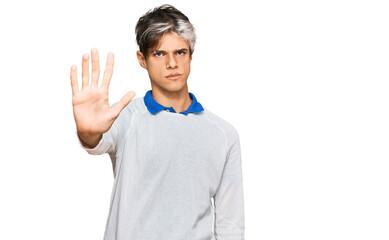 Young hispanic man wearing casual clothes doing stop sing with palm of the hand. warning expression...