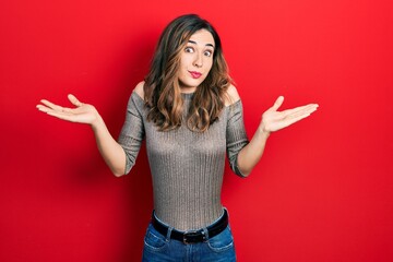 Young hispanic girl wearing casual clothes clueless and confused with open arms, no idea and doubtful face.