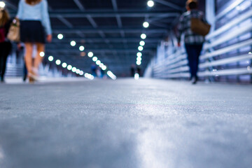 Pedestrian tunnel with lanterns. People go on the road. Night in the city. Close up view from the asphalt level.