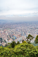 Visitors take in breathtaking views of Bogota on a spring day in Mount Monserrate. Colombia, skyscrapers