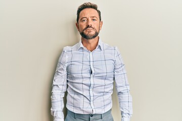 Middle age man wearing business clothes with serious expression on face. simple and natural looking at the camera.