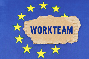 There is a cardboard box on the EU flag that says- WORKTEAM