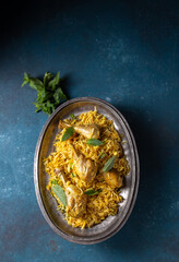 Chiken biryani Rice with yogur and mint on metal, top view. Pakistani and indian dish