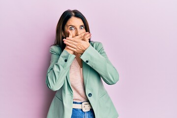 Middle age brunette woman wearing casual clothes shocked covering mouth with hands for mistake. secret concept.