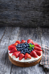 Victoria sponge cake on rustic wooden table