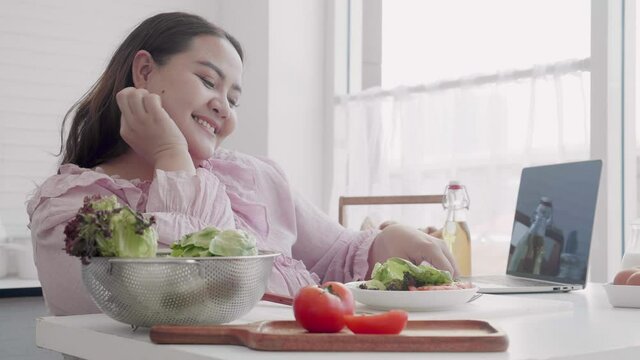 Young asian woman fat happy eating vegetable salad for dieting weight loss at home, healthy food, plus size, vegetarian and nutrition for wellness, female with expression, breakfast for obesity.