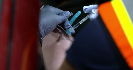 close up of person getting a needle poke from a covid vaccination syringe 